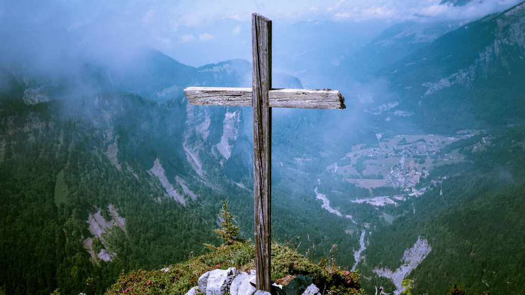 brown-wooden-cross-at-cliff
