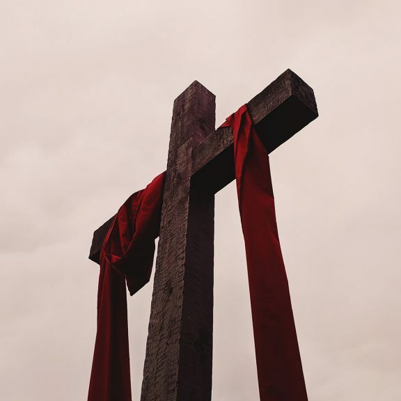 low-angle-view-of-cross-with-red-garment